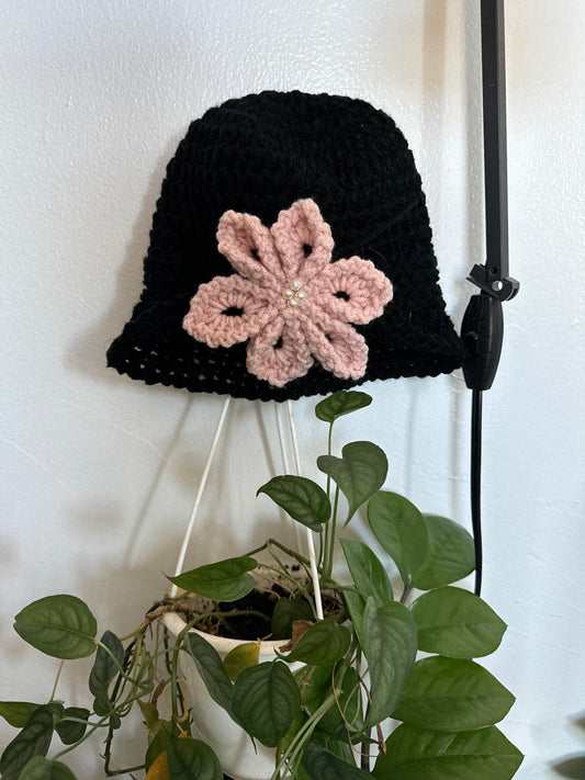 Black hat pink flower